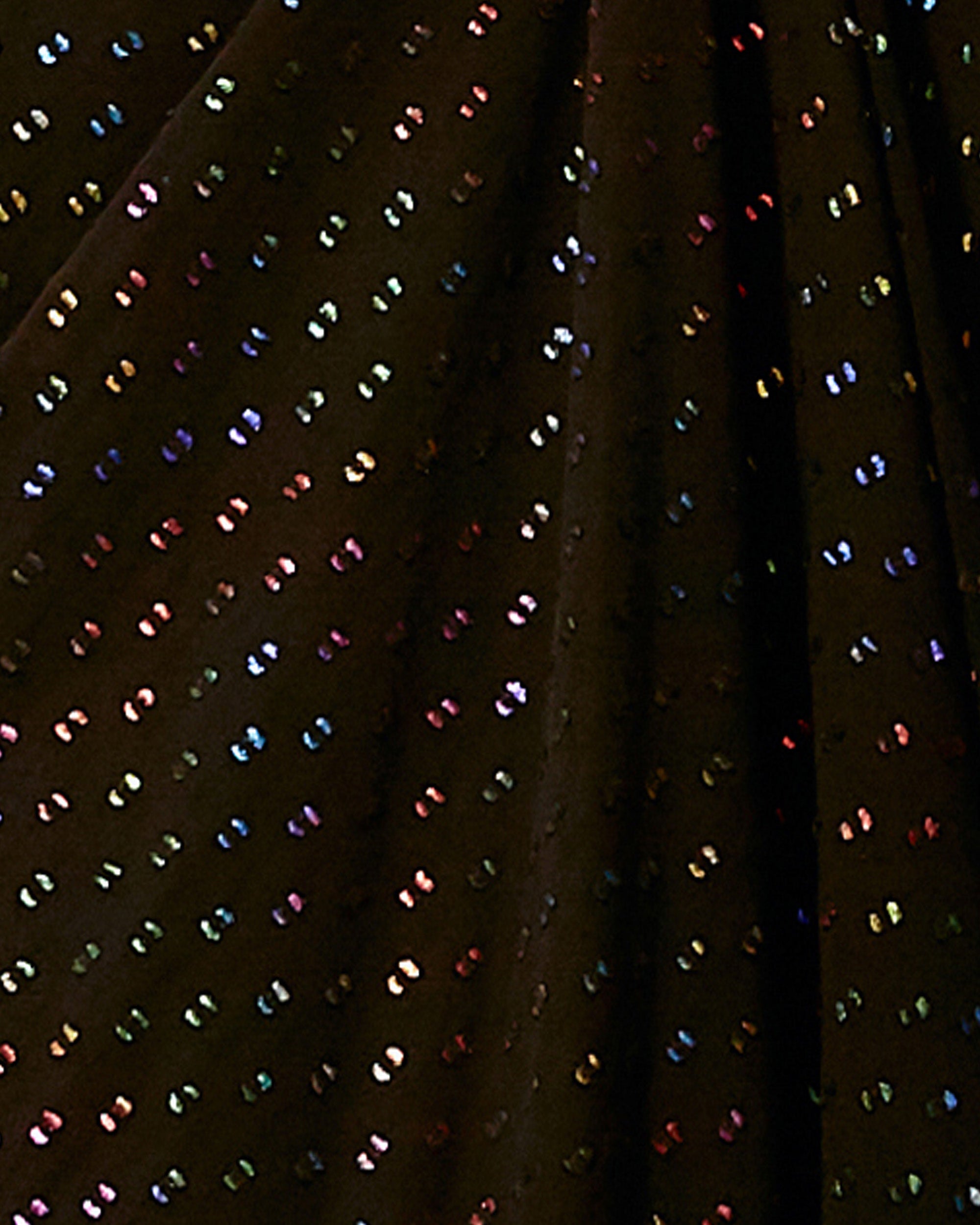 A close-up of a multicolored sequined black fabric.