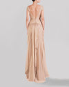 The back of a long beige evening dress featuring a draped lace bodice, short sleeves, an asymmetrical gathered skirt, and a deep V-shape open back.