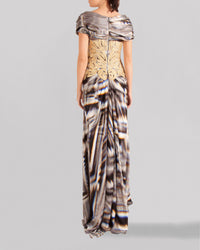 The back of a long multicolored evening dress featuring short sleeves and an embroidered lace bodice.