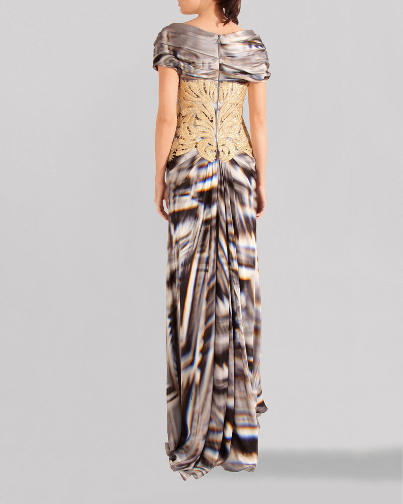 The back of a long multicolored evening dress featuring short sleeves and an embroidered lace bodice.