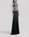 An evening wear set featuring a lace halter top in shades of green with a ruffled waist paired with a long flowy green skirt.