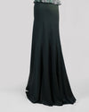 The back of long flowy green skirt.