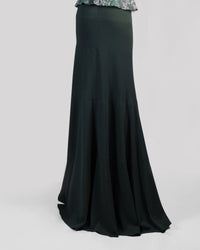 The back of long flowy green skirt.