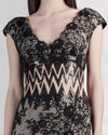 A close-up of a long black lace evening dress with small sleeves and a zigzag see-through waist detailing.