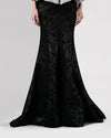 A long black mermaid cut skirt in a shimmery mesh fabric.