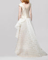 The back of an off-the-shoulders asymmetrical beige evening dress featuring a fitted bodice and lurex organza jacquard skirt.