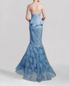 The back of a long blue strapless evening gown featuring a draped bodice and a mermaid-cut skirt.