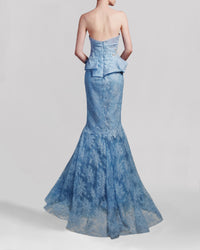 The back of a long blue strapless evening gown featuring a draped bodice and a mermaid-cut skirt.