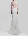 The back of a long ivory dress featuring a a see-through lace back with short-sleeves.