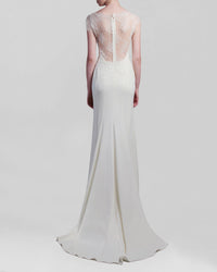 The back of a long ivory dress featuring a a see-through lace back with short-sleeves.