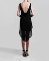 The back of a short black evening dress with an asymmetrical chiffon overlay, featuring an open back.