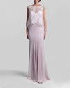 A long strapless pink evening dress with a heart-shaped neckline paired with an overlay lace top.