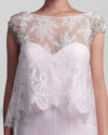 A close-up of a long strapless pink evening dress featuring a heart-shaped neckline paired with an overlay lace top.