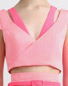 A two tone pink cropped jacquard top with cut out details.